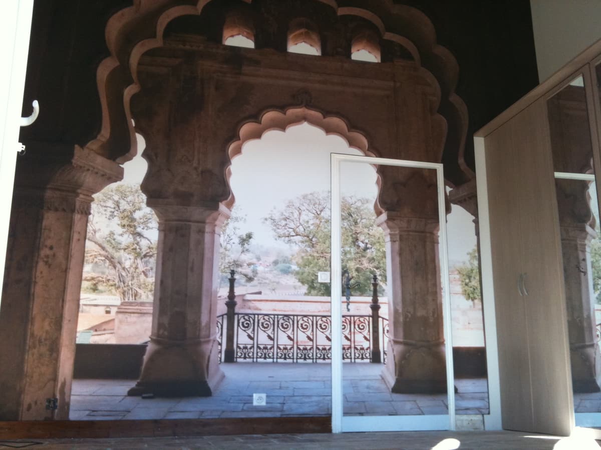 Toile imprimée : arches de pierre en perspective sur un mur de chambre